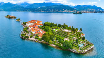 cenic view of Isola Bella on Lake Maggiore, showcasing the island’s ornate gardens and historic palazzo surrounded by blue lake waters and distant mountains.