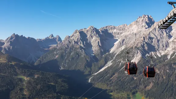 Cable car Tre Cime (Drei Zinnen) with scenic view of ridge summit Dreischusterspitze in majestic mountain range of untamed Sexten Dolomites, South Tyrol, Italy, Europe. Hiking concept Italian Alps