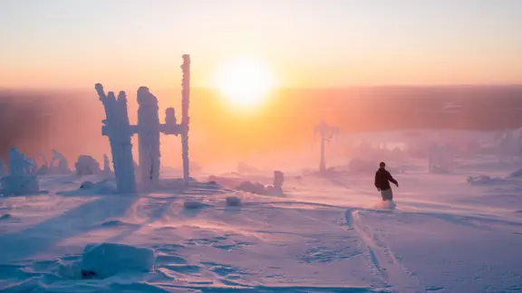 Snowboarding Next To Huttu Ukko Statue