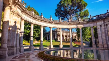 Ornate classical pillars at Montecatini Terme, part of the town’s historic thermal spa architecture, set against a clear sky.