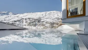 A look of the Hotel's outdoor pool, with beautiful snowy mountains spanning the horizon.